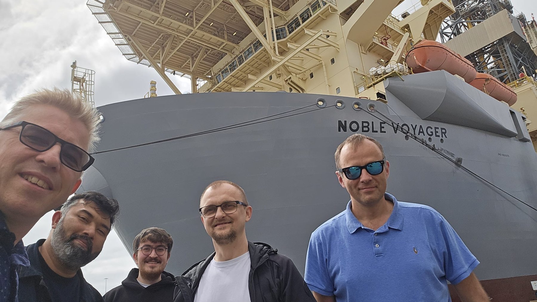 Daniel Czarkowski with four colleagues in front of Noble Voyager