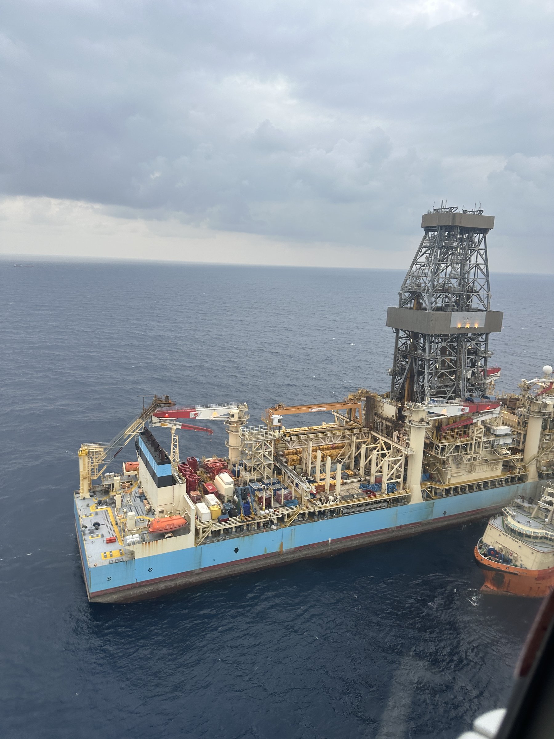 Drillship and supply vessel from a helicopter window