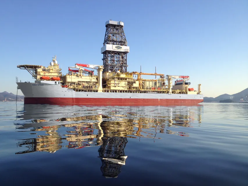 Noble Voyager at anchor, mirror-calm water